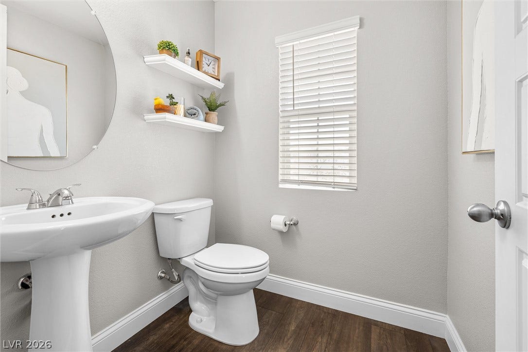 44 Kimberlite Drive, Henderson, NV 89011 This clean and bright powder room features warm wood flooring and elegant white fixtures.