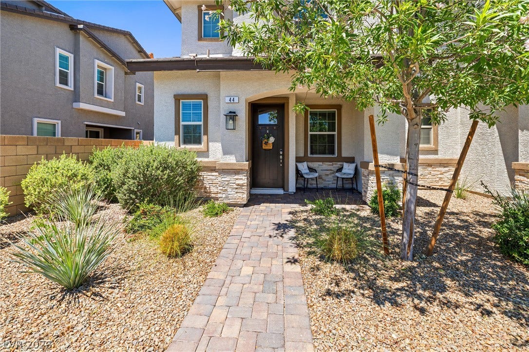 44 Kimberlite Drive, Henderson, NV 89011 This home features a welcoming covered entry and an arid-friendly landscaped yard with an elevated view.