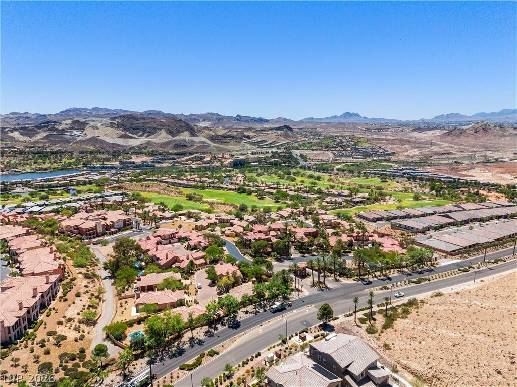 44 Kimberlite Drive, Henderson, NV 89011 An aerial perspective reveals a vibrant community nestled within a desert landscape, featuring residential areas and recreational facilities.
