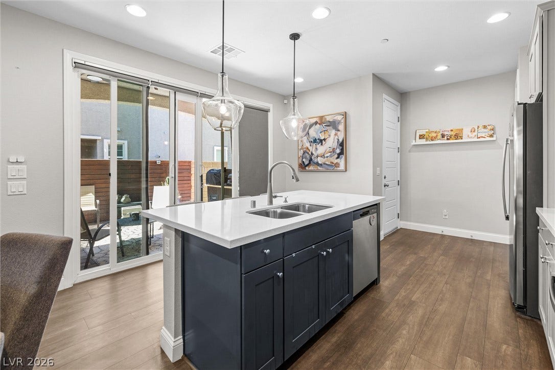 44 Kimberlite Drive, Henderson, NV 89011 This contemporary kitchen features a spacious island and seamless access to outdoor living.
