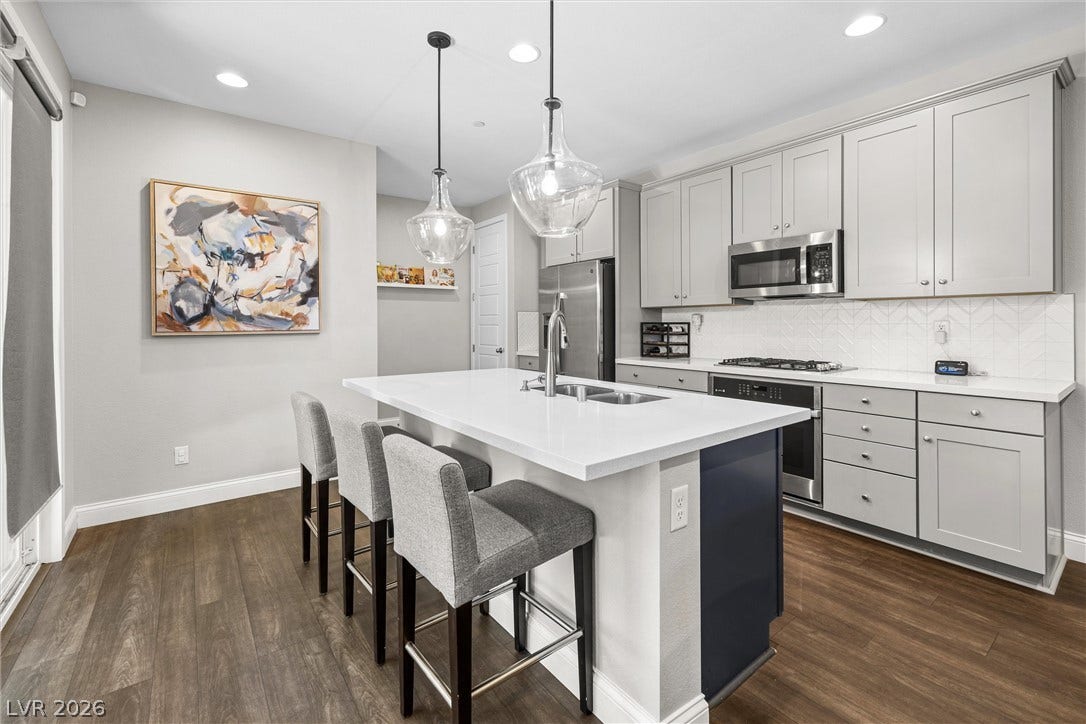 44 Kimberlite Drive, Henderson, NV 89011 This kitchen features a central island with sleek countertops and integrated stainless steel appliances.