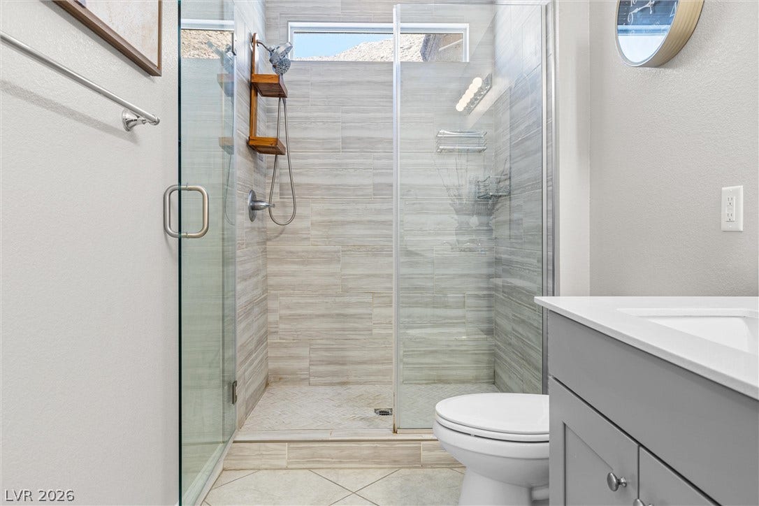 44 Kimberlite Drive, Henderson, NV 89011 Modern bathroom featuring a spacious glass-enclosed shower with contemporary tile work.