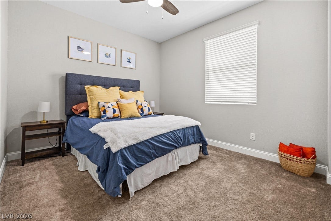 44 Kimberlite Drive, Henderson, NV 89011 This 2nd bedroom features plush carpeting and a bright window, creating a serene and inviting atmosphere.