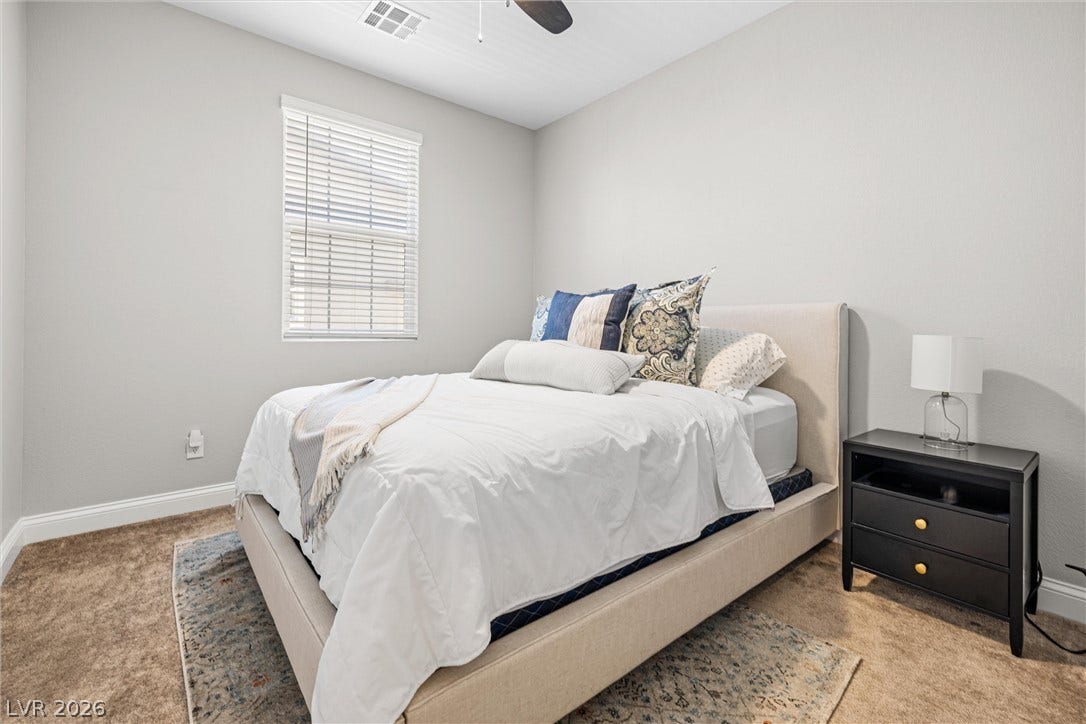 44 Kimberlite Drive, Henderson, NV 89011 This 3rd bedroom offers a tranquil retreat with soft lighting and ample space.