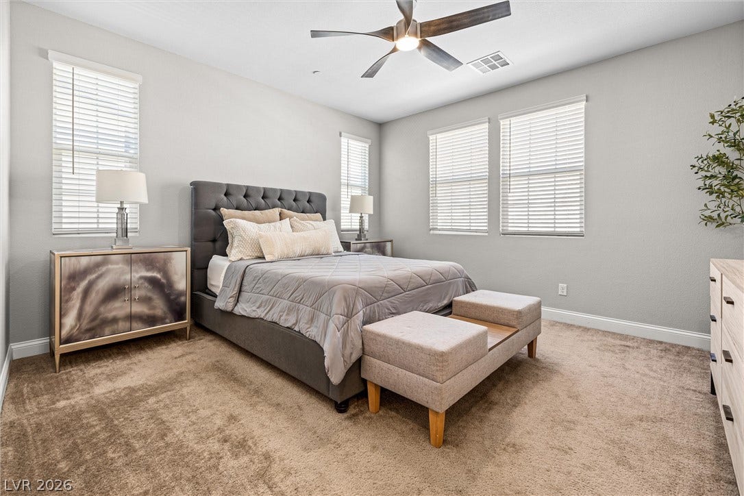 44 Kimberlite Drive, Henderson, NV 89011 This large primary bedroom features soft carpet and ample natural light, offering a comfortable personal retreat.