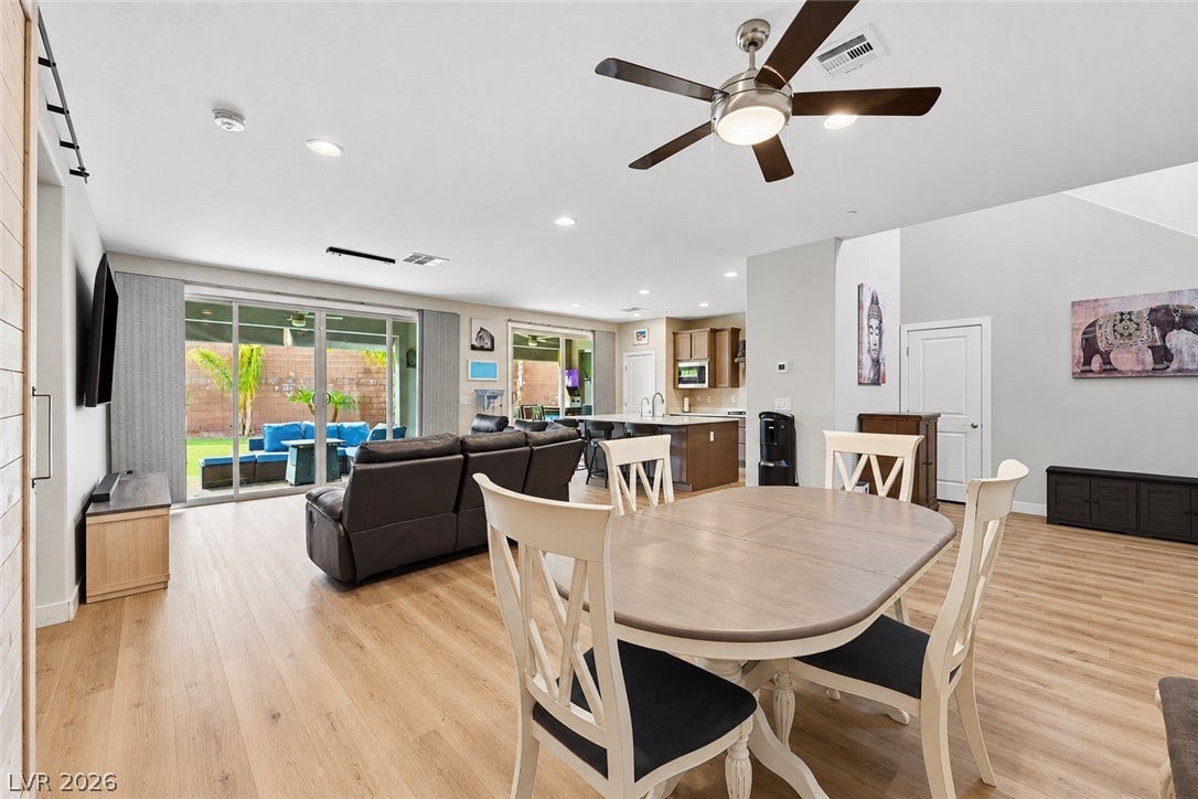 31 Cresta Villa Court, Henderson, NV 89011 An airy open concept layout integrates dining, living, and kitchen spaces over handsome wood-look floors.