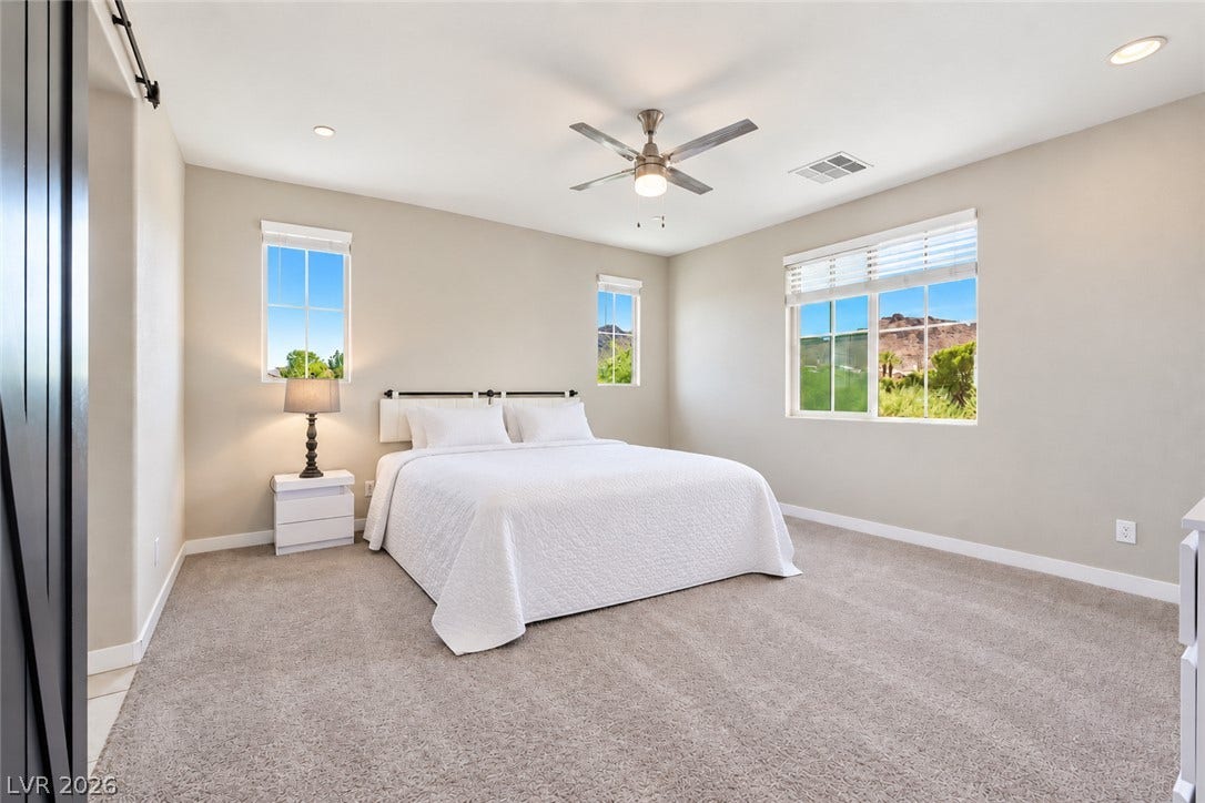 31 Cresta Villa Court, Henderson, NV 89011 Plentiful natural light streams through multiple windows highlighting soft, neutral-toned carpeting.