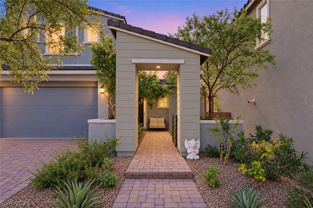 31 Cresta Villa Court, Henderson, NV 89011 A paved path leads through a covered entry structure to a private courtyard.