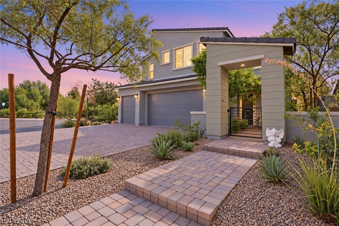 31 Cresta Villa Court, Henderson, NV 89011 Elegant desert landscaping frames a paved pathway leading to a gated entry courtyard.