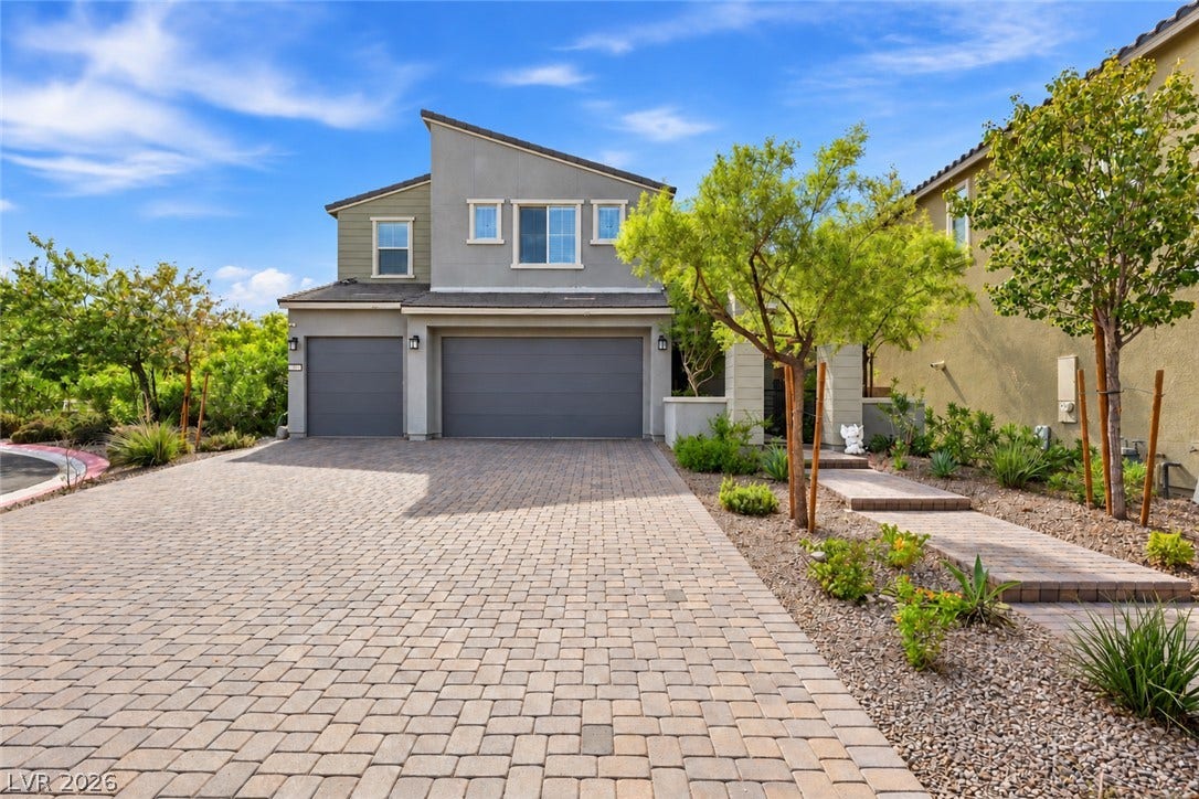 31 Cresta Villa Court, Henderson, NV 89011 A spacious paved driveway leads to the multi-car garage of this contemporary two-story home.