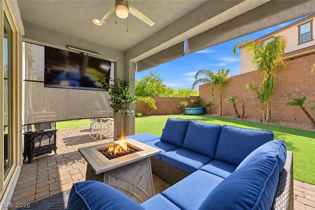 31 Cresta Villa Court, Henderson, NV 89011 A sheltered paver patio looks out over a private yard with manicured synthetic turf.