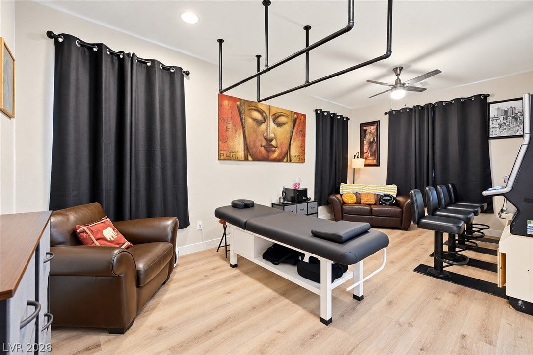 31 Cresta Villa Court, Henderson, NV 89011 Smooth wood-style flooring and recessed lighting define this versatile recreation space.