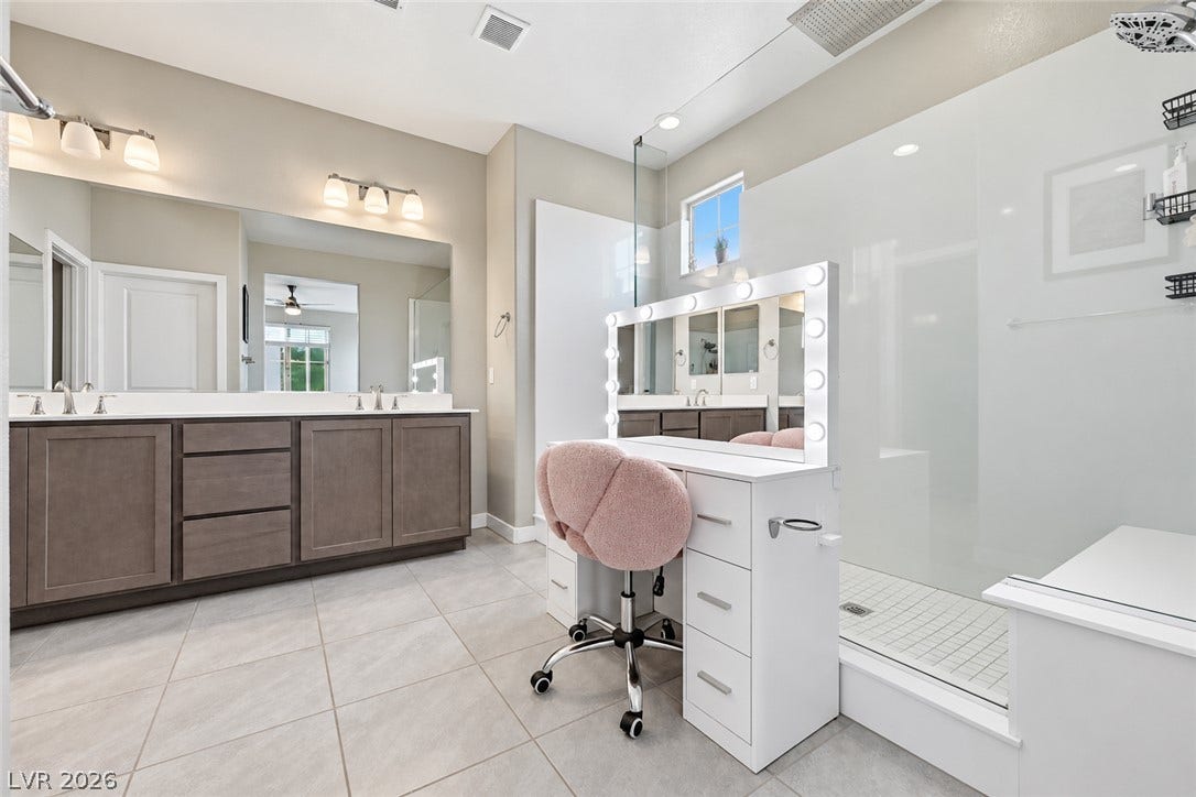 31 Cresta Villa Court, Henderson, NV 89011 A spacious bathroom displays a modern tiled floor and a walk-in glass shower.