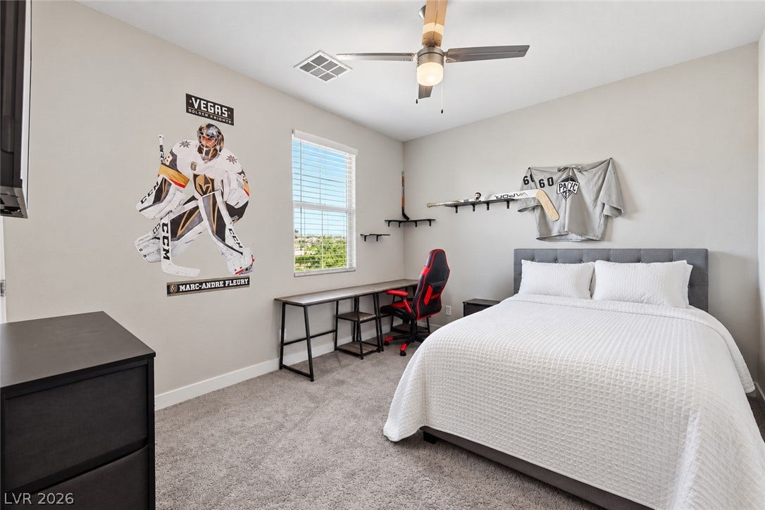31 Cresta Villa Court, Henderson, NV 89011 Soft carpeting pairs with neutral walls and a bright window in this comfortable bedroom.