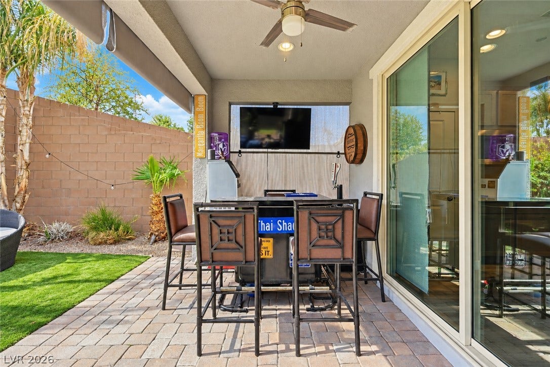 31 Cresta Villa Court, Henderson, NV 89011 An inviting covered patio features integrated block pavers alongside sliding glass doors.