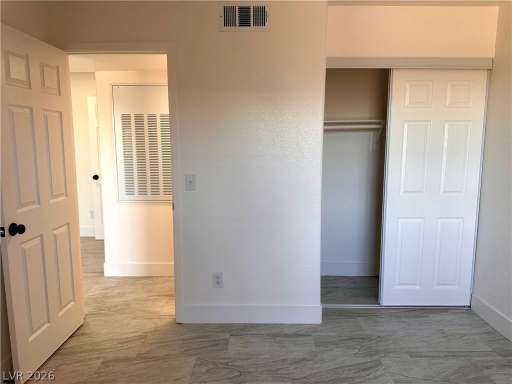 230 Mission Catalina Lane, #107, Las Vegas, NV 89107 Smooth tile flooring runs through the bedroom and closet spaces.