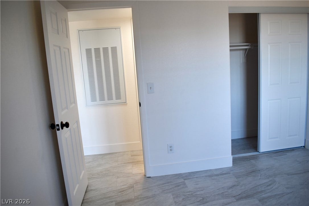 230 Mission Catalina Lane, #107, Las Vegas, NV 89107 Sleek modern flooring flows past the sliding closet doors into a bright hallway.