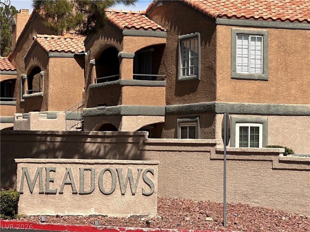 230 Mission Catalina Lane, #107, Las Vegas, NV 89107 Distinctive southwestern architectural styling defines this multi-level residential exterior with classic tile roofing.