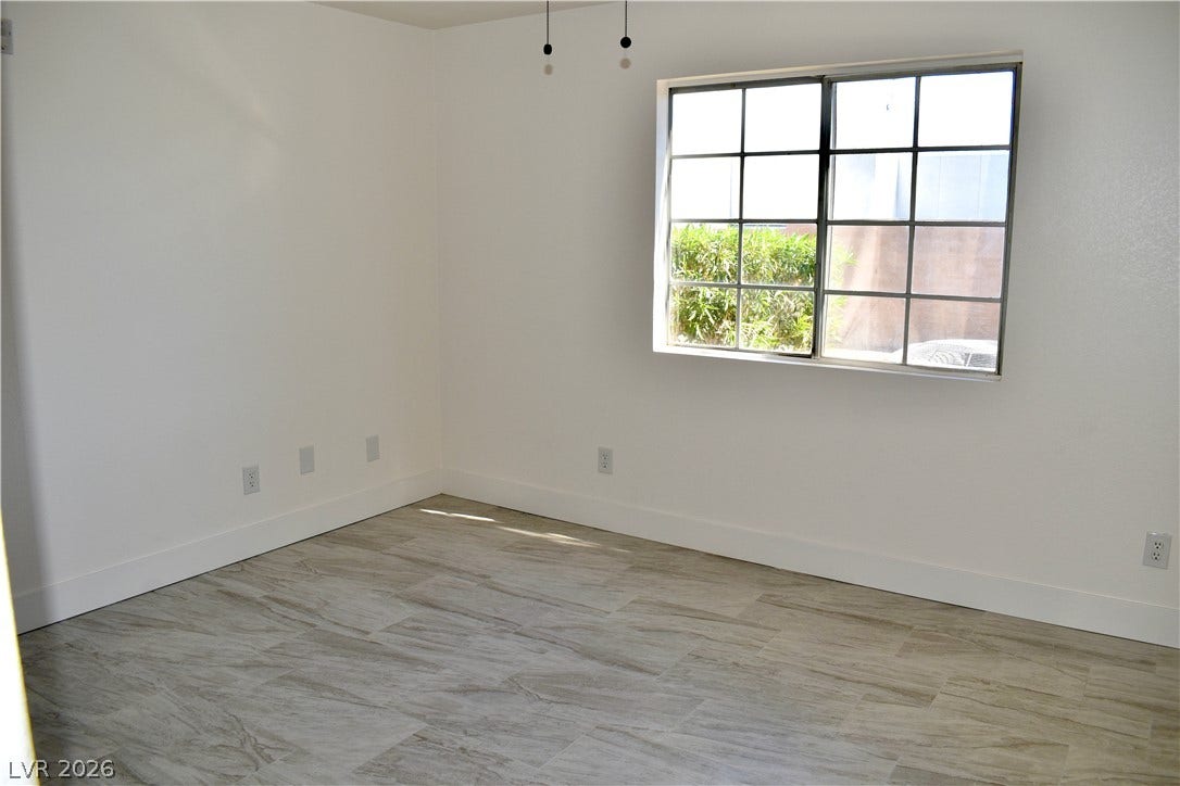 230 Mission Catalina Lane, #107, Las Vegas, NV 89107 Multi-pane windows fill this versatile room with natural light highlighting the neutral tile flooring.