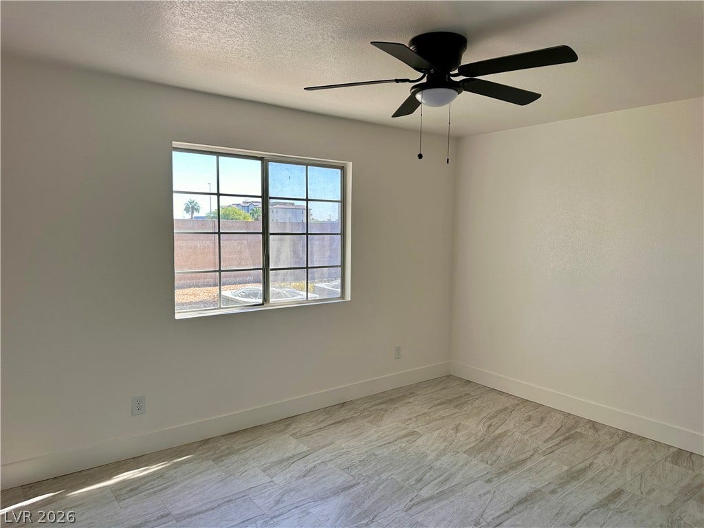 230 Mission Catalina Lane, #107, Las Vegas, NV 89107 Gleaming tile floors and a classic multi-pane window elevate this sun-washed room.