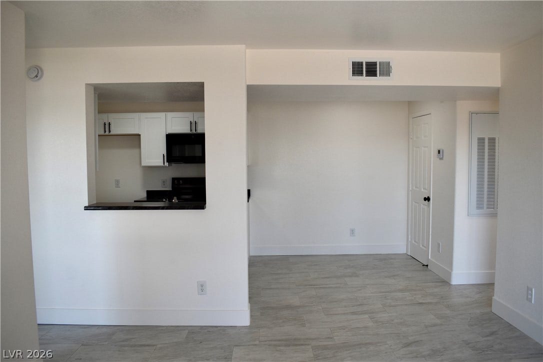 230 Mission Catalina Lane, #107, Las Vegas, NV 89107 An open pass-through window connects the functional kitchen to a versatile dining area.
