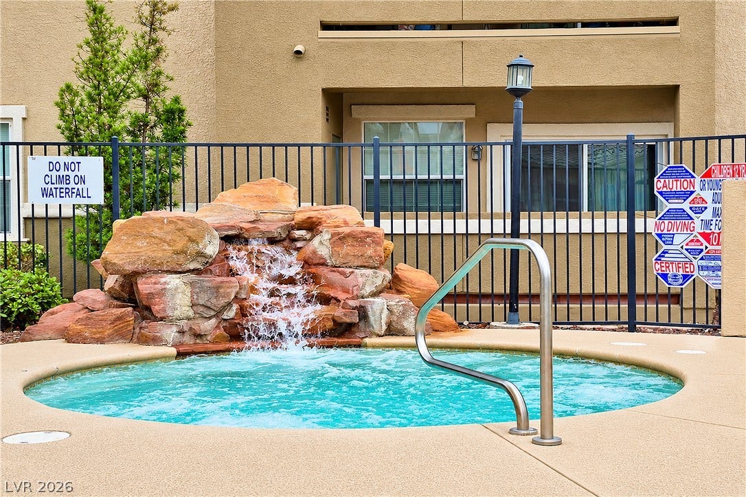 8777 W Maule Avenue, #2109, Las Vegas, NV 89148 An inviting circular spa highlighted by a cascading stone waterfall feature.