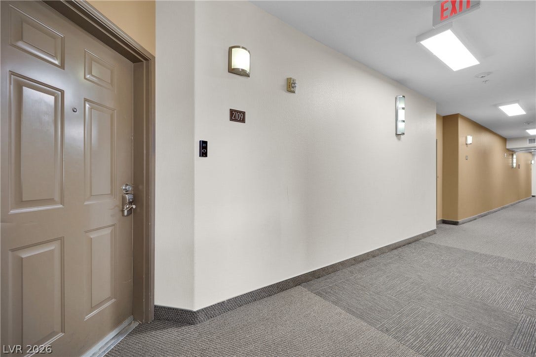 8777 W Maule Avenue, #2109, Las Vegas, NV 89148 Clean lines and durable carpet tile flooring define the secure, well-lit residential corridor.