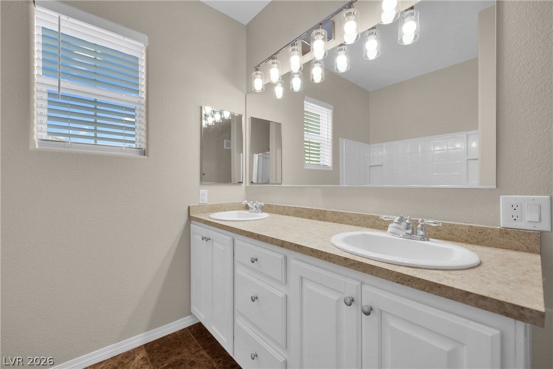 8777 W Maule Avenue, #2109, Las Vegas, NV 89148 A spacious double vanity and tile flooring highlight this bathroom design.