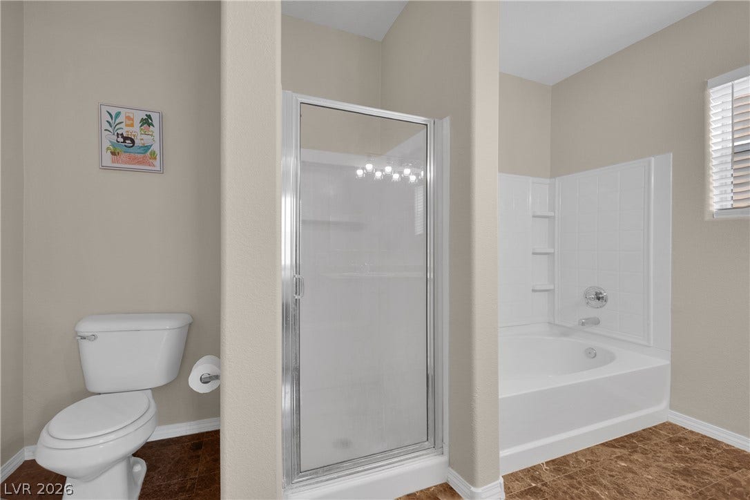 8777 W Maule Avenue, #2109, Las Vegas, NV 89148 High ceilings and a separate soaking tub create a relaxing atmosphere in this bathroom.