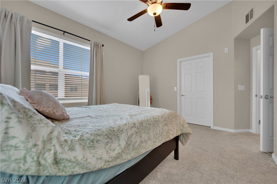 8777 W Maule Avenue, #2109, Las Vegas, NV 89148 A spacious bedroom offers vaulted ceilings, soft carpeting, and a wide window.