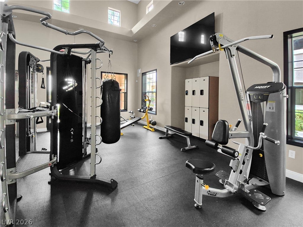 8777 W Maule Avenue, #2109, Las Vegas, NV 89148 High ceilings and tall windows create a bright atmosphere in this home gym space.