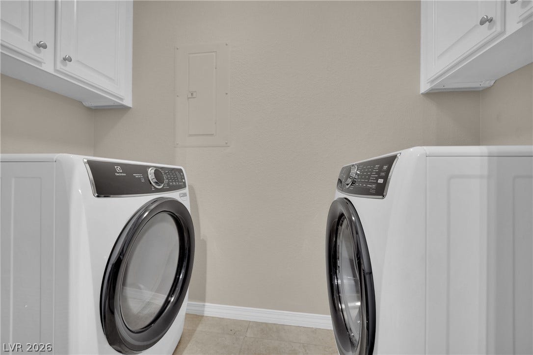 8777 W Maule Avenue, #2109, Las Vegas, NV 89148 Functional laundry space includes built-in white upper cabinetry and tiled flooring.