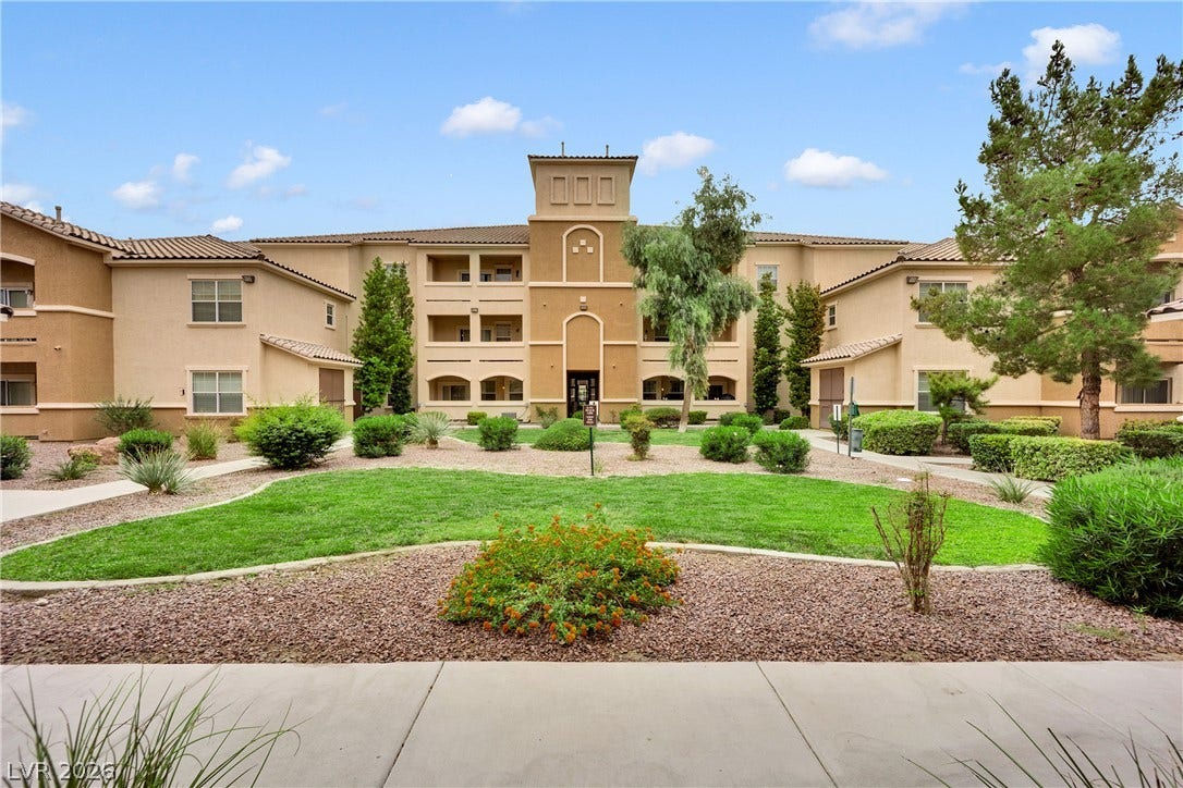 8777 W Maule Avenue, #2109, Las Vegas, NV 89148 Manicured green lawns and desert plantings surround the classic multi-level stucco facade.