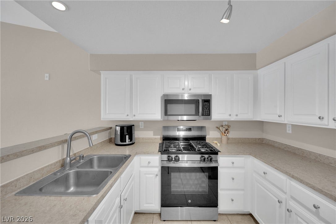 8777 W Maule Avenue, #2109, Las Vegas, NV 89148 Crisp white cabinetry pairs perfectly with ample counter space in this efficient kitchen layout.