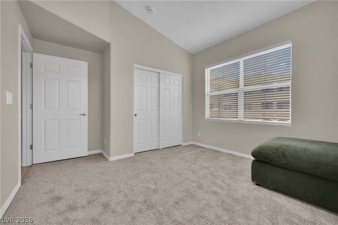 8777 W Maule Avenue, #2109, Las Vegas, NV 89148 Plush carpeting anchors this bedroom under a vaulted ceiling line.
