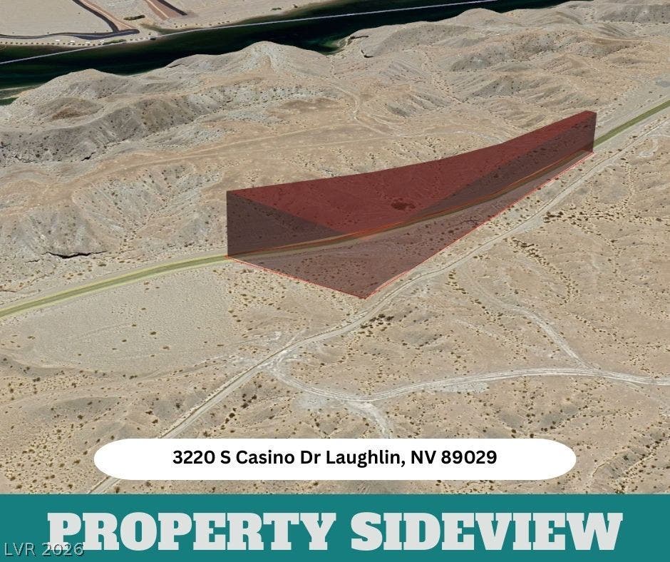 3220 Casino Dr, Laughlin, NV 89029 An aerial perspective showcases a sprawling desert parcel near the winding river.