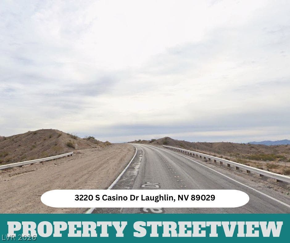 3220 Casino Dr, Laughlin, NV 89029 Desert hills frame the paved road leading toward this Laughlin property location.