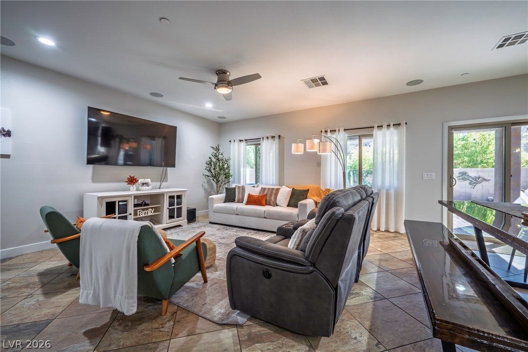 152 Dunblane Street, Henderson, NV 89012 Gleaming tile floors and natural light from sliding glass doors enhance this welcoming living area.