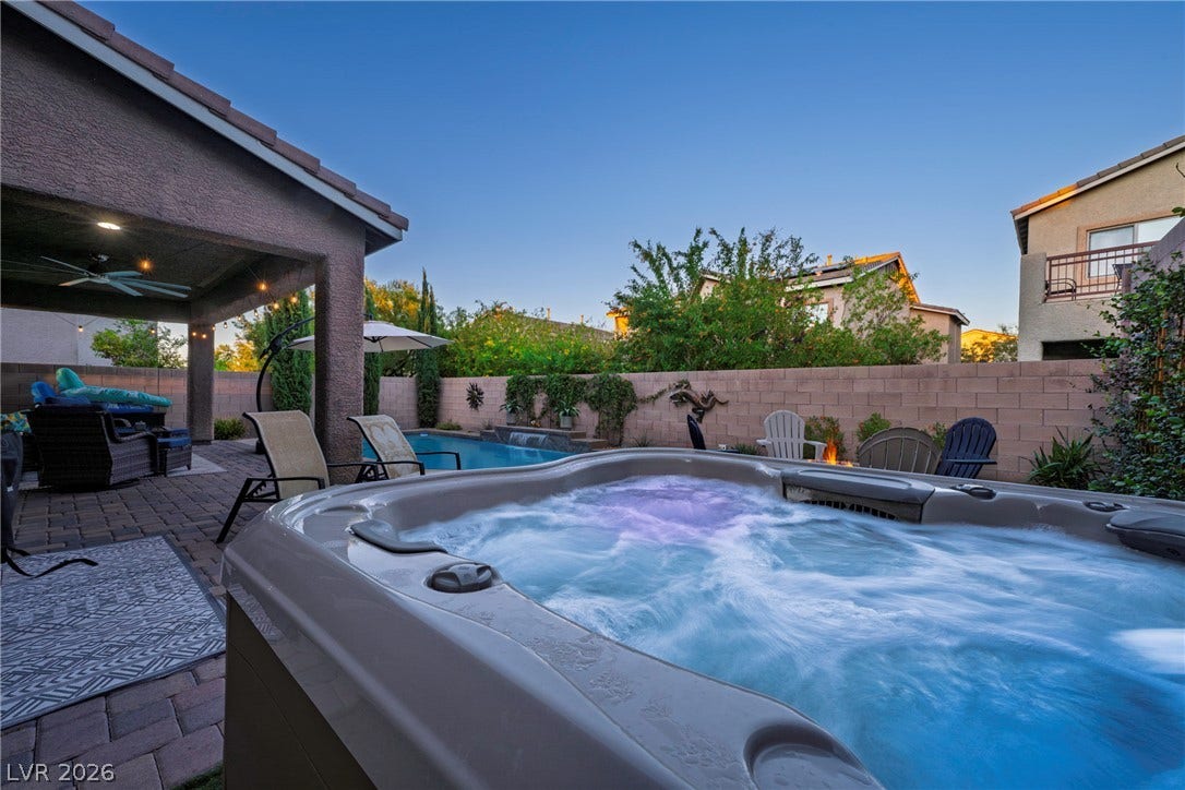 152 Dunblane Street, Henderson, NV 89012 An inviting backyard oasis features a bubbling spa alongside a sparkling swimming pool.