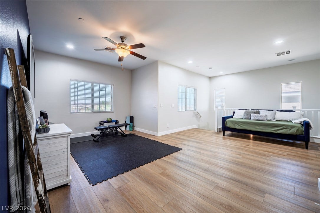 152 Dunblane Street, Henderson, NV 89012 An open second-floor loft features smooth wood-plank flooring and clean recessed lighting.