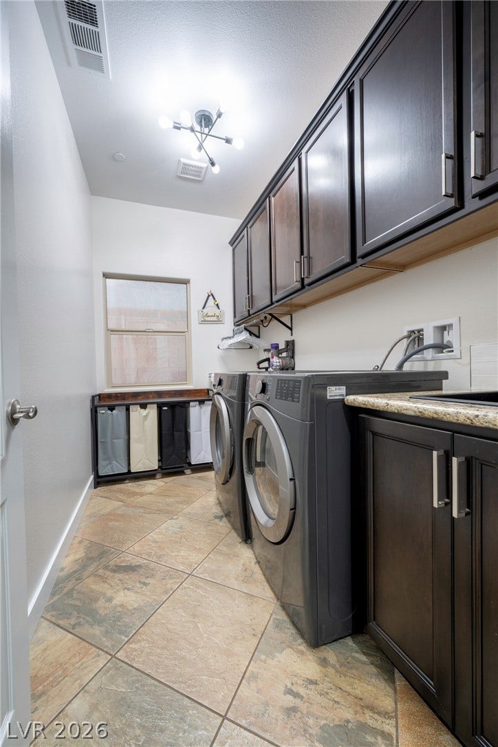 152 Dunblane Street, Henderson, NV 89012 Rich dark cabinetry and stone-look tile flooring define this highly functional workspace.