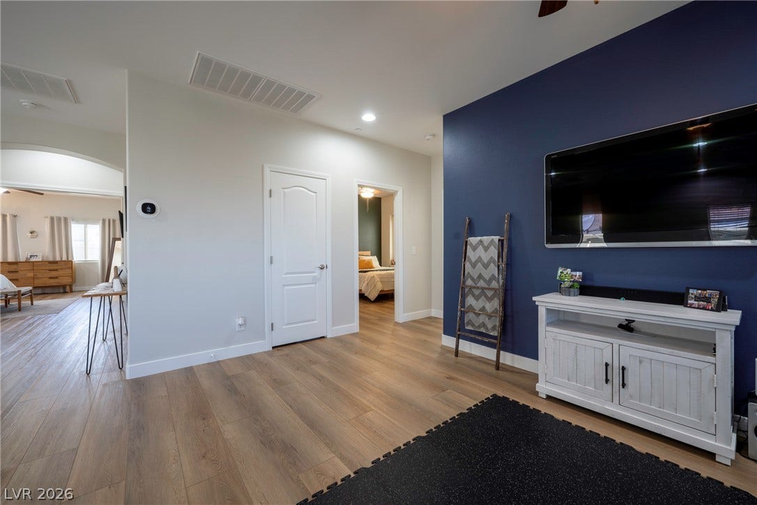 152 Dunblane Street, Henderson, NV 89012 Gleaming wood-look floors flow throughout the versatile open space adjacent to bedrooms.