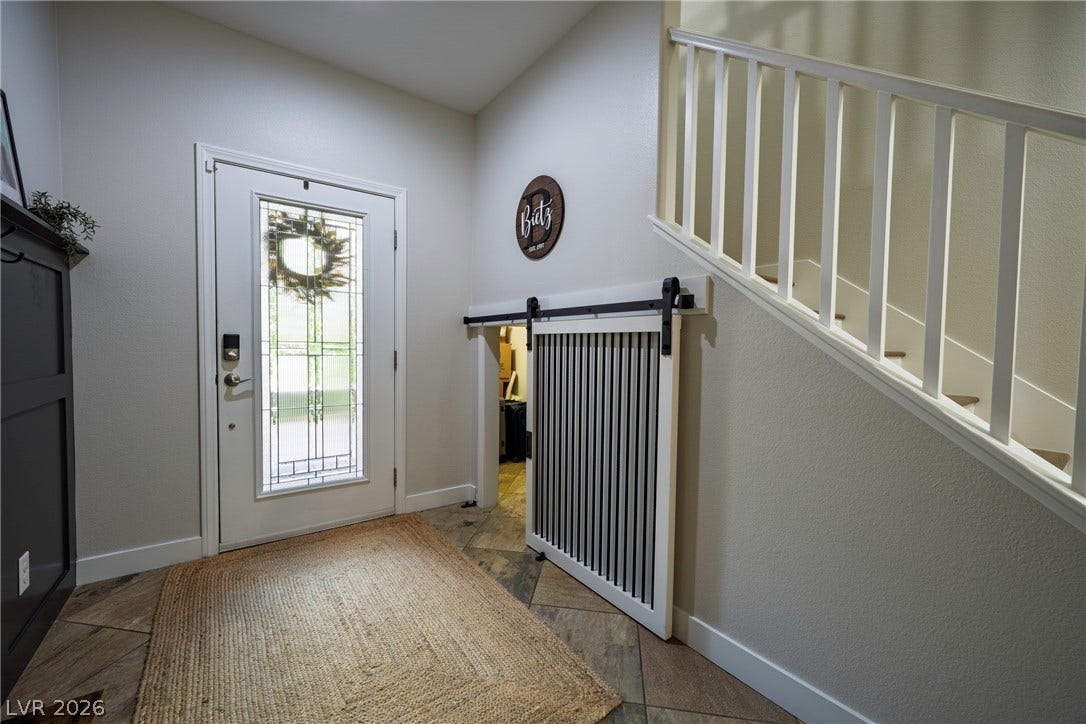 152 Dunblane Street, Henderson, NV 89012 Welcoming entryway showcases tile flooring and a built-in sliding barn door under the stairs.