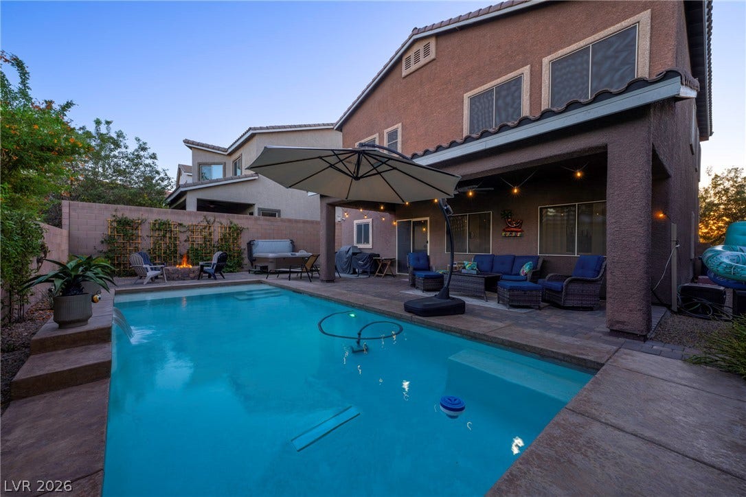 152 Dunblane Street, Henderson, NV 89012 A refreshing swimming pool sits adjacent to a covered patio and paved lounging areas.