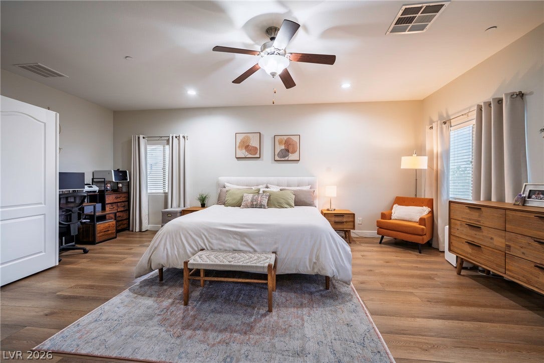 152 Dunblane Street, Henderson, NV 89012 Warm wood flooring and recessed lighting define this comfortable, airy sleeping space.