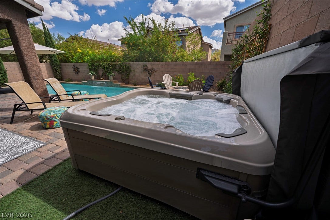 152 Dunblane Street, Henderson, NV 89012 A relaxing spa sits beside the swimming pool in this private back yard.