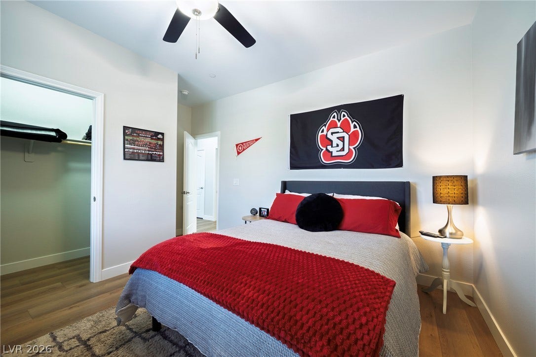152 Dunblane Street, Henderson, NV 89012 Smooth wood flooring and a walk-in closet highlight this comfortable bedroom space.
