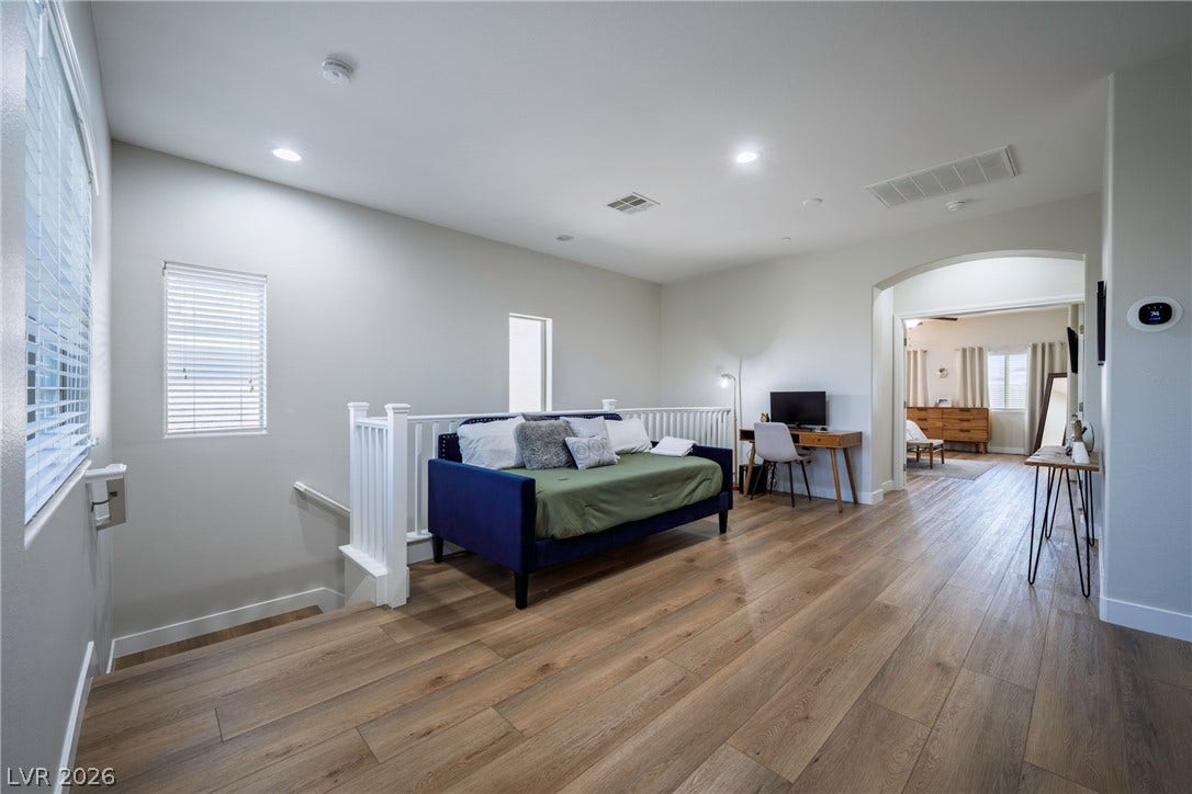152 Dunblane Street, Henderson, NV 89012 Smooth wood-look flooring and an arched transition highlight this versatile upper-level bonus space.