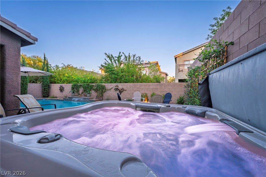 152 Dunblane Street, Henderson, NV 89012 An inviting hot tub overlooks the sparkling backyard swimming pool and stone boundary walls.