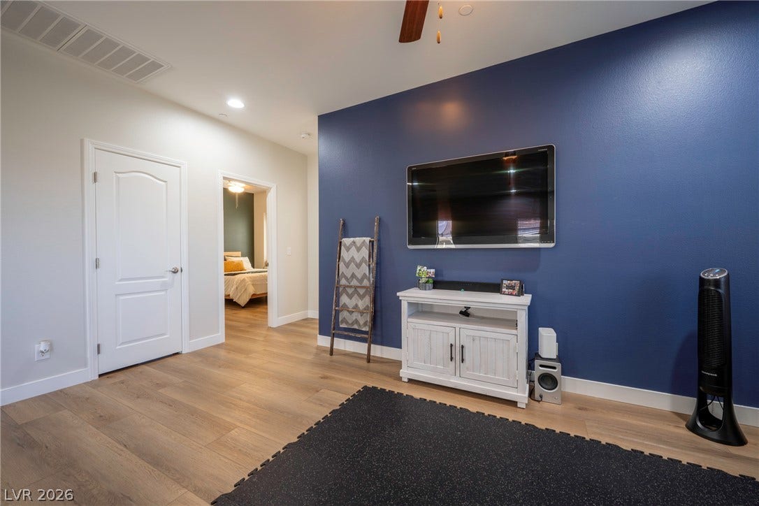 152 Dunblane Street, Henderson, NV 89012 Smooth wood flooring and recessed lighting set a clean tone in this versatile room.